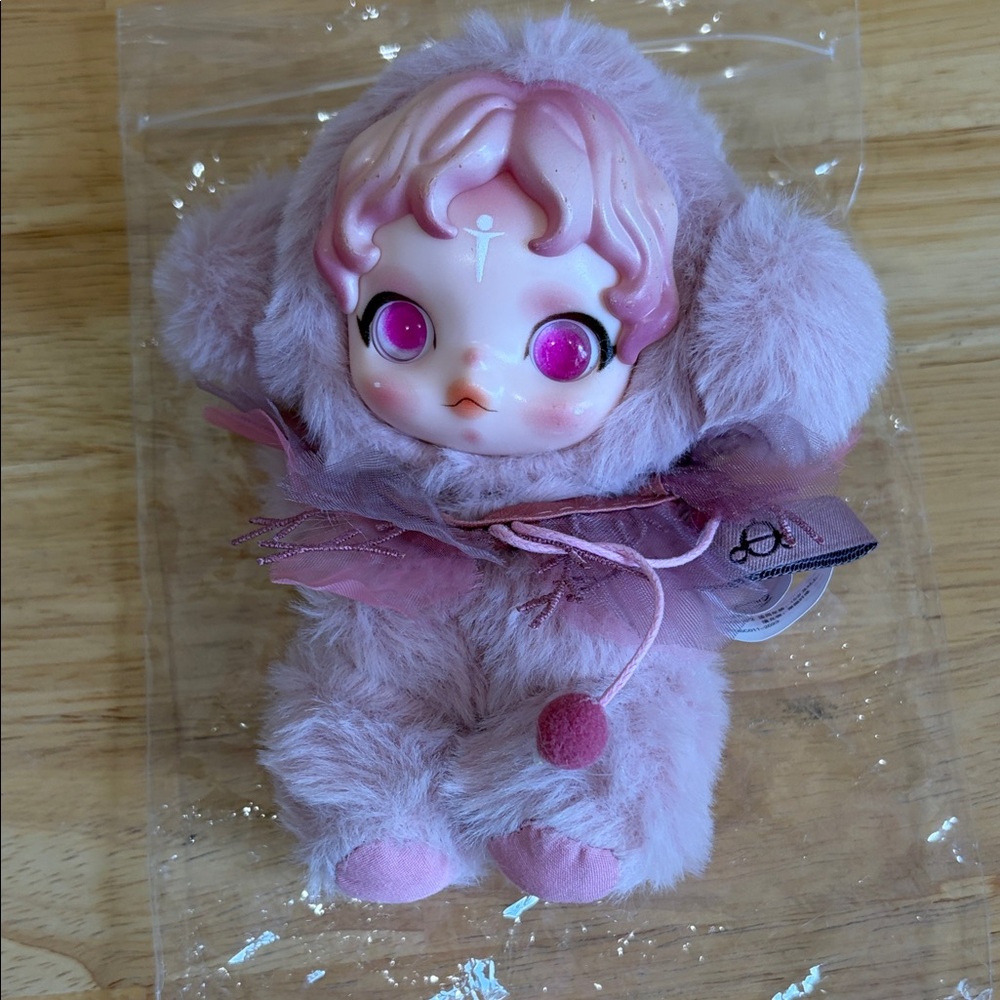 Plush Pink Doll with Decorative Face and Fur Outfit